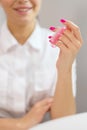 Closeup shot of woman in nail salon receiving manicure by beautician with nail file and machine. Woman getting nail Royalty Free Stock Photo