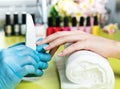 Closeup shot of a woman in a nail salon receiving a manicure by a beautician with nail file. Woman getting nail manicure Royalty Free Stock Photo
