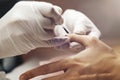 Closeup shot of a woman receiving a manicure by a beautician.