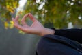 Closeup shot of a woman's hand making a mudra jnana gesture while doing a yoga