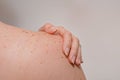 Closeup shot of the woman's torso from behind with her hand on the shoulder. Royalty Free Stock Photo