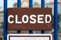 Closeup shot of a wooden Closed sign on the blue fence Royalty Free Stock Photo