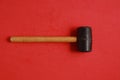 Closeup shot of wooden hammer isolated on a red background Royalty Free Stock Photo