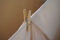 Closeup shot of a wooden pin holding cloth rope with blur background