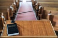 Closeup shot of a wooden pulpit with a microphone and a black bible