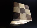 Closeup shot of wooden Rubik's cube isolated on a black background