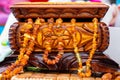 Closeup shot of a wooden small chest with some amber necklaces