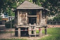 Closeup shot of a wooden small playground house surrounded by a restricting line