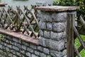 Closeup shot of a wooden wattle fence in a garden near a rural house Royalty Free Stock Photo