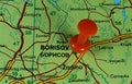 Closeup shot of a world map with a red pushpin pointing the city of Borisov in Belarus