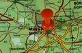 Closeup shot of a world map with a red pushpin pointing the city of Minsk in Belarus