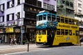 Closeup shot of a yellow autobus driving in the street in Wan Chai, Hong Kong