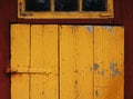 Closeup shot of a yellow door detail of a typical Swedish wood house