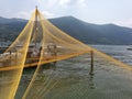 Closeup shot of yellow lift fishing nets placed by docks Royalty Free Stock Photo