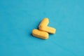 Closeup shot of yellow pills on a blue background Royalty Free Stock Photo