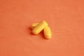 Closeup shot of yellow pills on an orange background Royalty Free Stock Photo