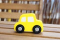 Closeup shot of a yellow toy car on a wooden surface Royalty Free Stock Photo