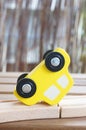 Closeup shot of a yellow toy car on a wooden surface Royalty Free Stock Photo