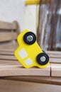 Closeup shot of a yellow toy car on a wooden surface Royalty Free Stock Photo