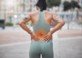 Closeup shot of a young african american woman suffering with back pain while working out in the city. Superimposed cgi Royalty Free Stock Photo