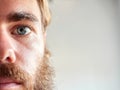 Closeup shot of a young attractive man with blue eyes and a beard Royalty Free Stock Photo