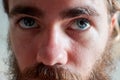 Closeup shot of a young attractive man with blue eyes and a beard Royalty Free Stock Photo