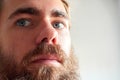 Closeup shot of a young attractive man with blue eyes and a beard Royalty Free Stock Photo