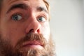 Closeup shot of a young attractive man with blue eyes and a beard Royalty Free Stock Photo