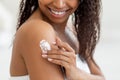 Closeup Shot Of Young Black Female Rubbing Moisturising Lotion To Skin Royalty Free Stock Photo