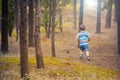 Closeup shot of a young boy walking in the forest Royalty Free Stock Photo