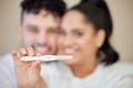 Were actually quite happy with this result. Closeup shot of a young couple looking happy with a negative pregnancy test