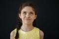 Closeup shot of young girl with ginger hair dressed in casual creamy white blouse looking at the camera with shame on Royalty Free Stock Photo