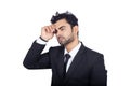 Closeup shot of a young Indian businessman thinking serious isolated white background Royalty Free Stock Photo