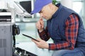 closeup shot young male technician repairing digital photocopier machine Royalty Free Stock Photo