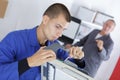 Closeup shot young male technician repairing digital photocopier machine Royalty Free Stock Photo