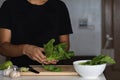 Closeup shot of a young man holding a bunch of spinach