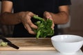 Closeup shot of a young man holding a bunch of spinach