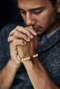 Praying for a miracle. Closeup shot of a young man praying with his eyes closed. Royalty Free Stock Photo