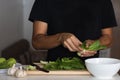 Closeup shot of a young man separating a bunch of spinach