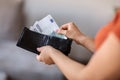 Closeup Shot Of Young Woman Taking Out Money From Wallet At Home Royalty Free Stock Photo