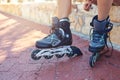 Time for these wheels to roll. Closeup shot of a young womans feet in rollerblades sitting on a park bench. Royalty Free Stock Photo