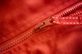 Closeup shot of a zipper on a red jacket