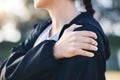 Closeup, shoulder pain and woman with stress, burnout and muscle tension with girl outdoor. Fitness, female athlete and Royalty Free Stock Photo