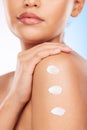 Closeup, shoulder and woman with cream, dermatology or wellness on a blue studio background. Zoom, person or model with