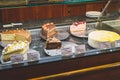 Closeup of a showcase with a variety of cakes in a restaurant