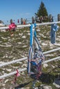 Gifts, momentoes hang from fencing around Native American medicine wheel on Montana mountain top. Royalty Free Stock Photo