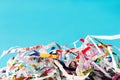 Closeup shredded paper texture and reuse colorful paper scrap of document on blue paper background. Selective focus image Royalty Free Stock Photo