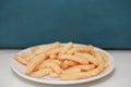 Closeup Shrimp cracker chips on a white paper plate.