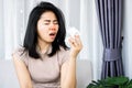 Sick Asian woman sneezing hand holding paper tissue having flu, runny nose caused of cold , allergy to dust Royalty Free Stock Photo