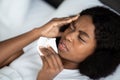 Closeup of sick black woman laying in bed Royalty Free Stock Photo
